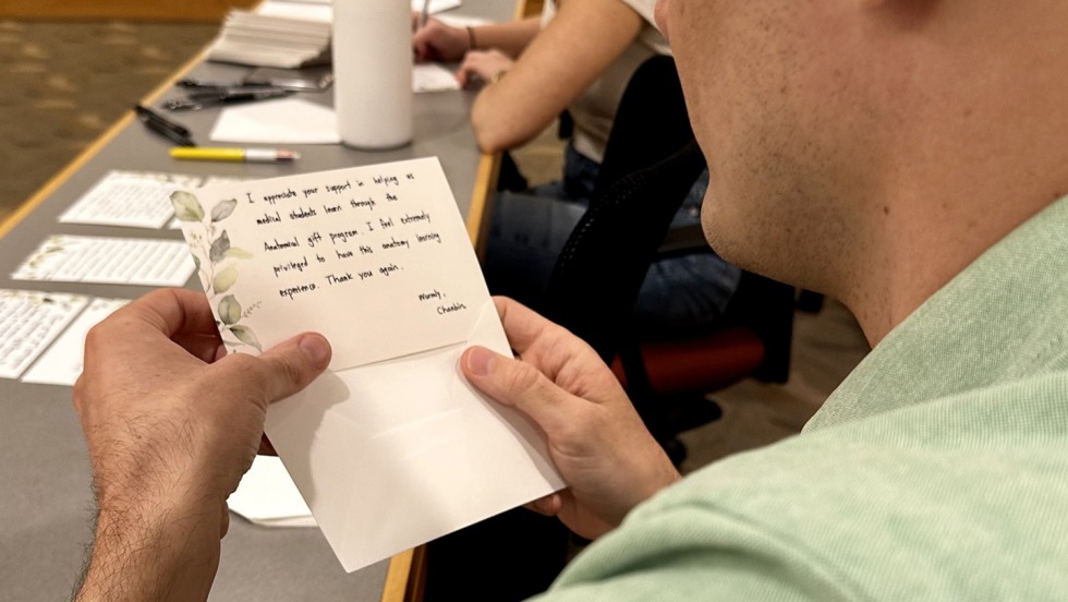 person writing a note on a card